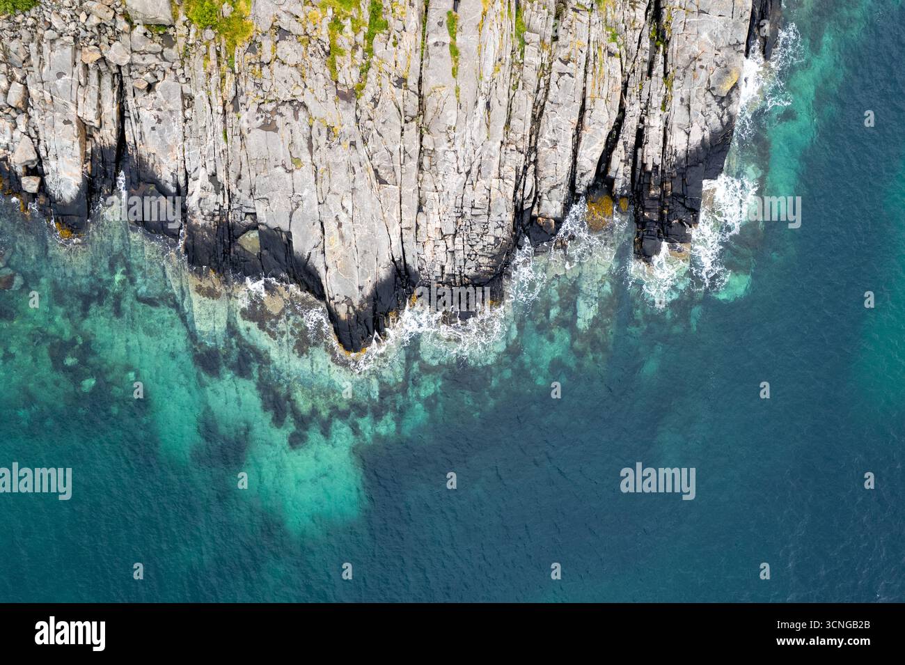 Turquoise water crashing on rocky coastline. Rocky seascape. Drone aerial landscape lofoten islands Stock Photo