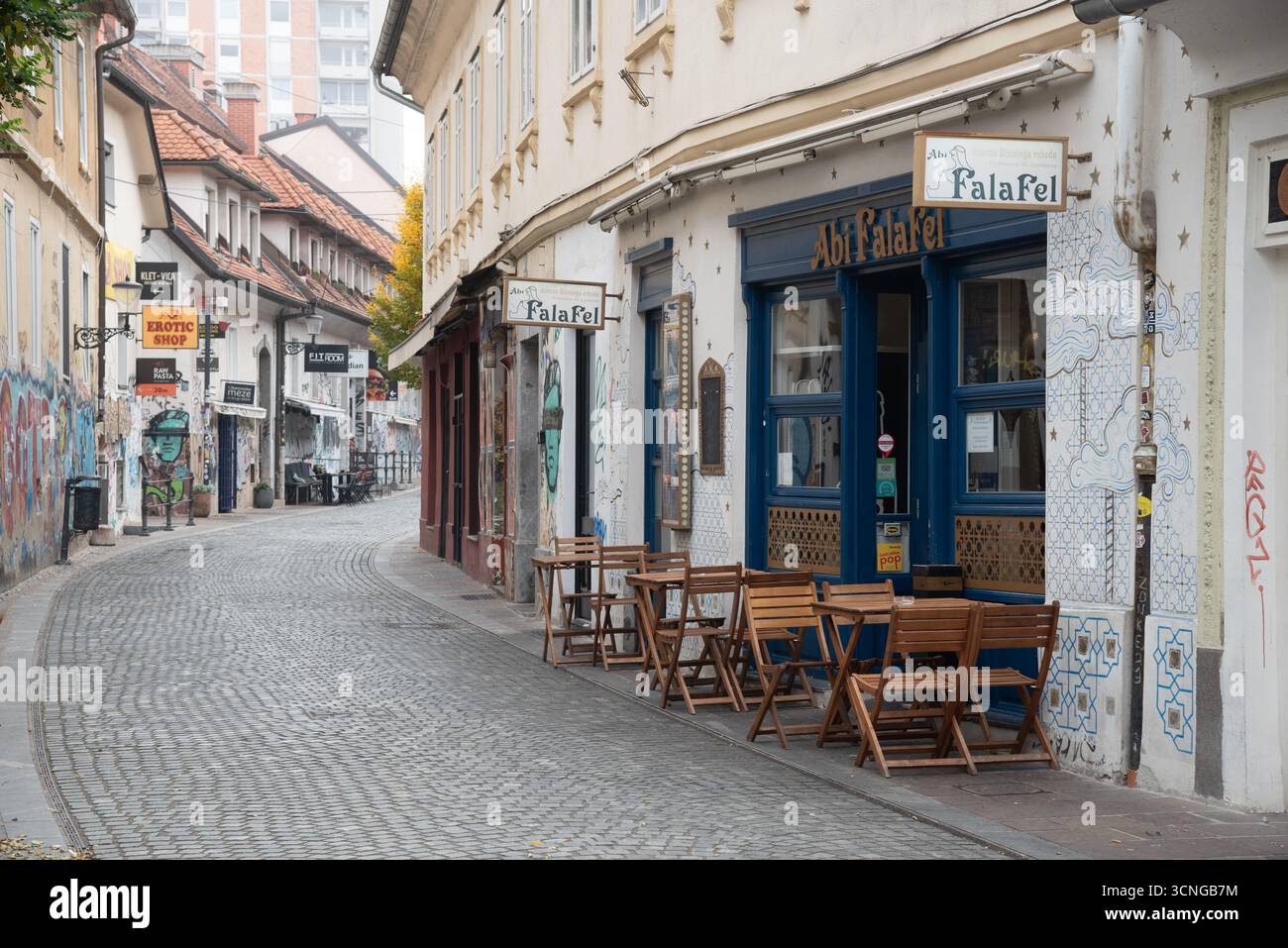Outdoor tables of a cafe in Ljubljana old city. cobblestone streets and charming architecture Stock Photo