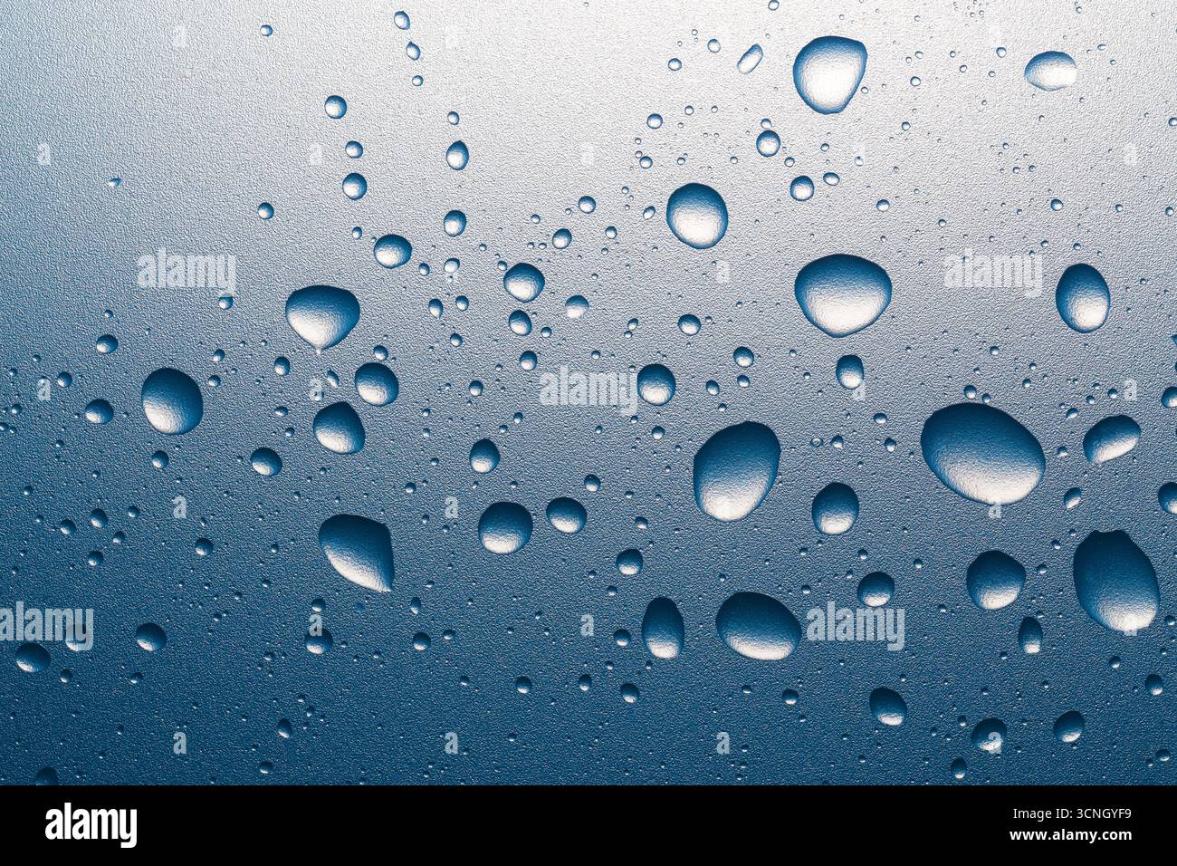 Water drops on a rough surface. Macro photography. Stock Photo