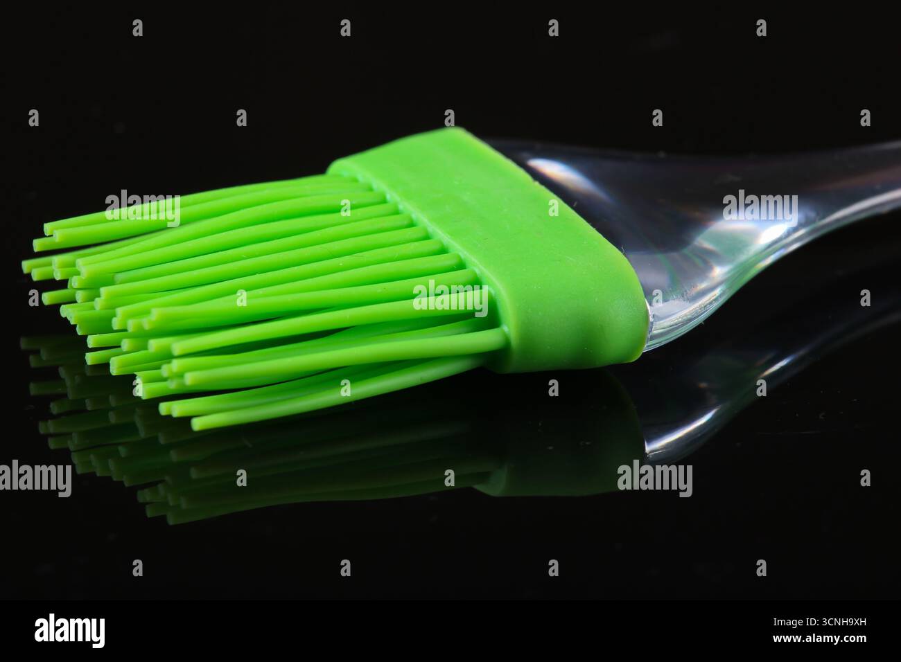 Silicone kitchen brush on a black background. Stock Photo