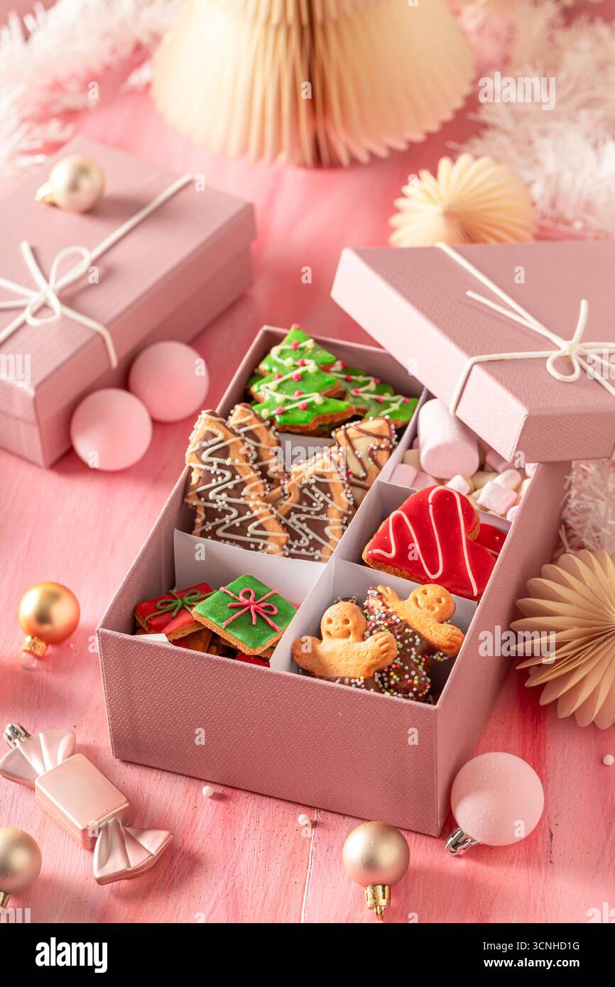 Tasty Christmas gingerbread cookies in rose gift box.. Cozy winter composition with treats. Stock Photo