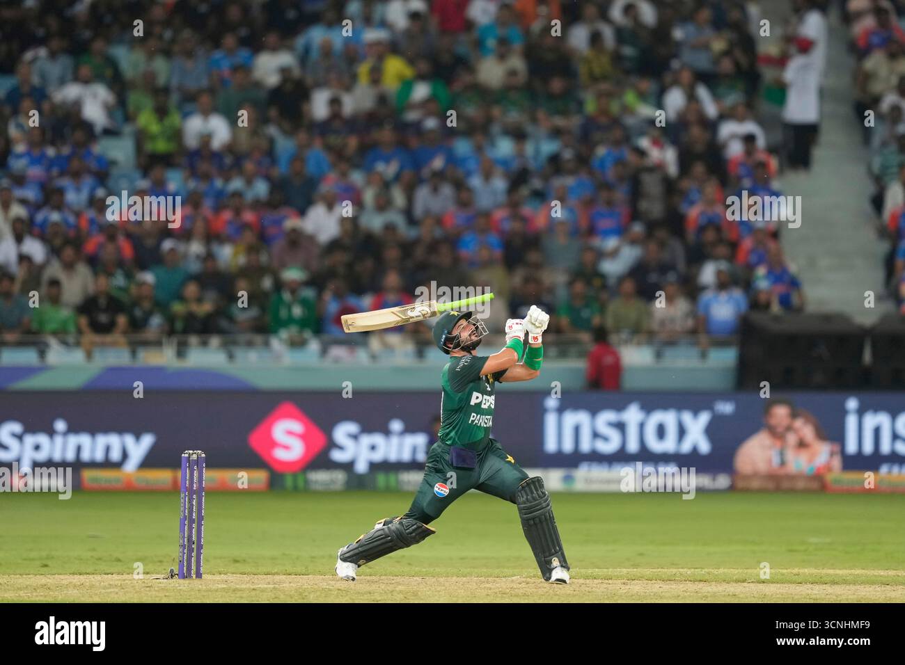 Pakistan's Sahibzada Farhan looses grip on his bat while playing a shot ...