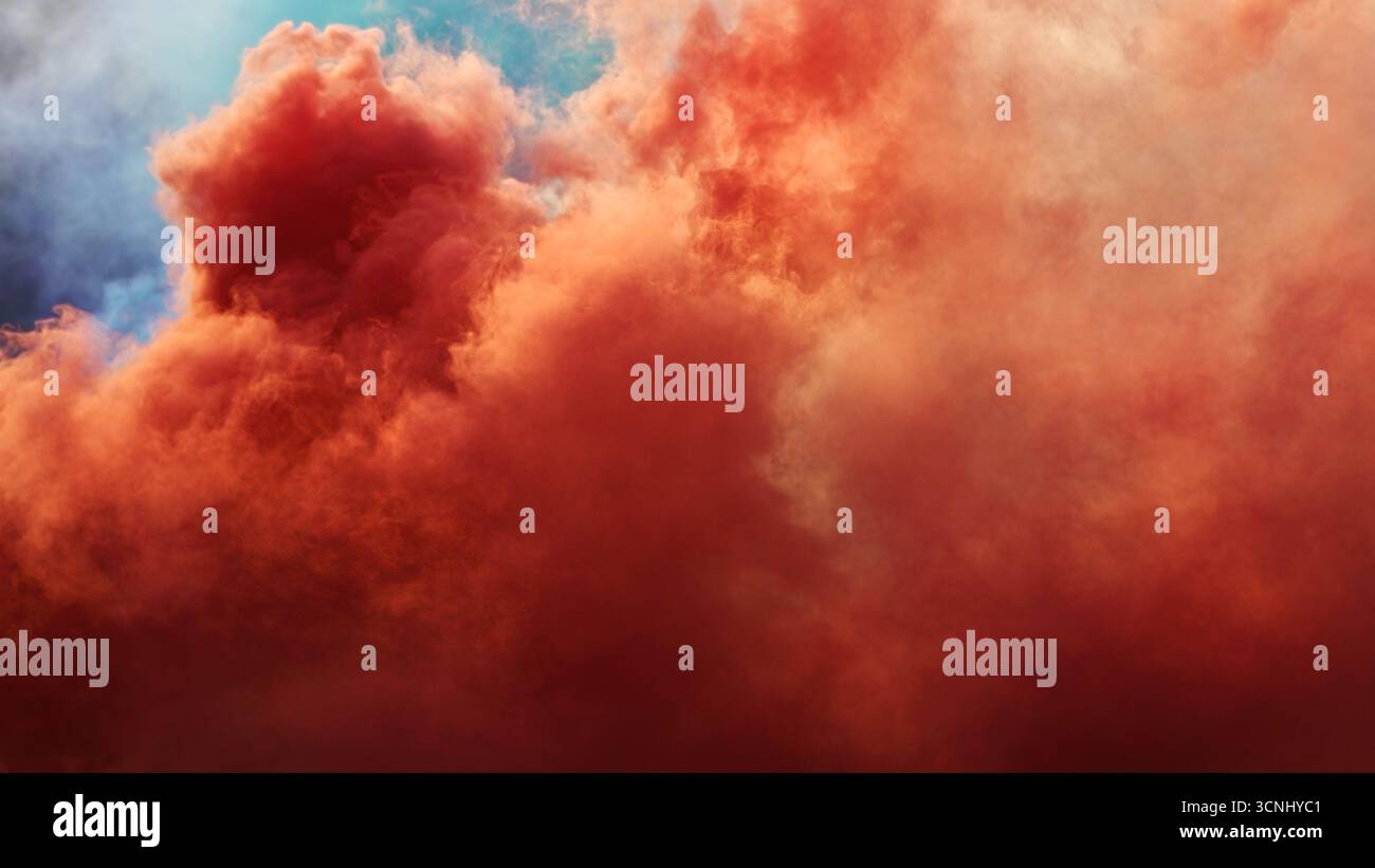 Dense red smoke drifting through air, festive abstract composition. Selective focus. Stock Photo