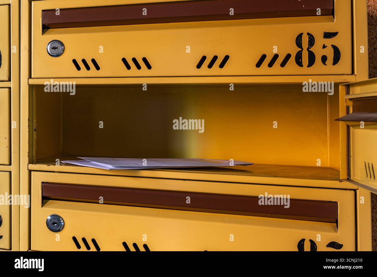 A man takes a letter out of a mailbox, a man puts a letter into a ...