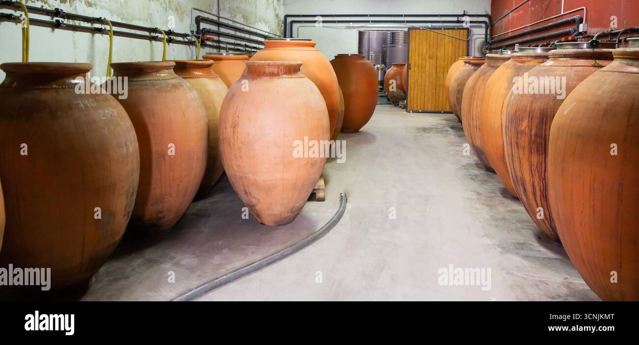 Clay vessels for wine fermentation in winery Stock Photo - Alamy