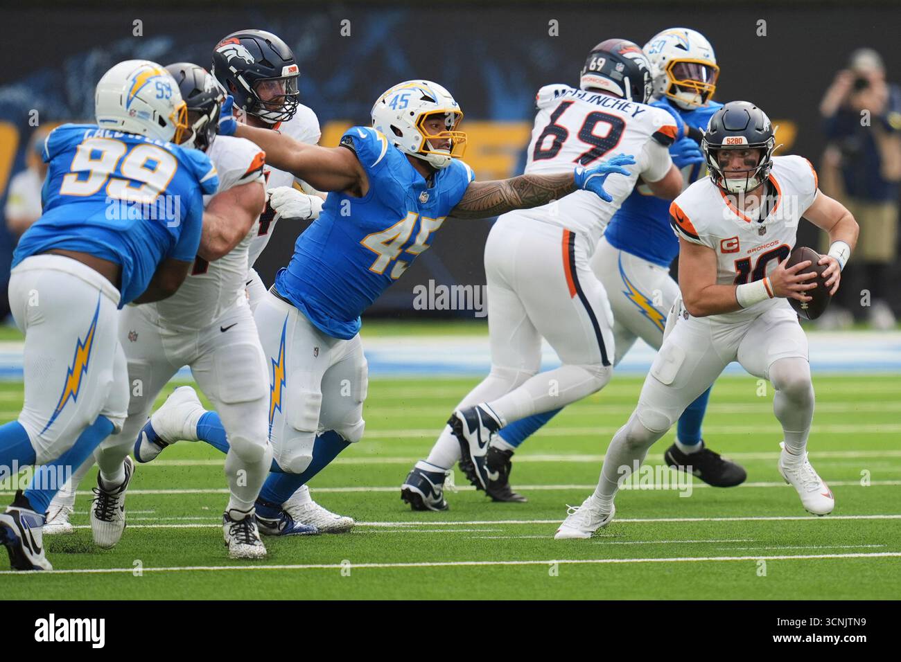 Denver Broncos quarterback Bo Nix (10) runs past Los Angeles Chargers ...