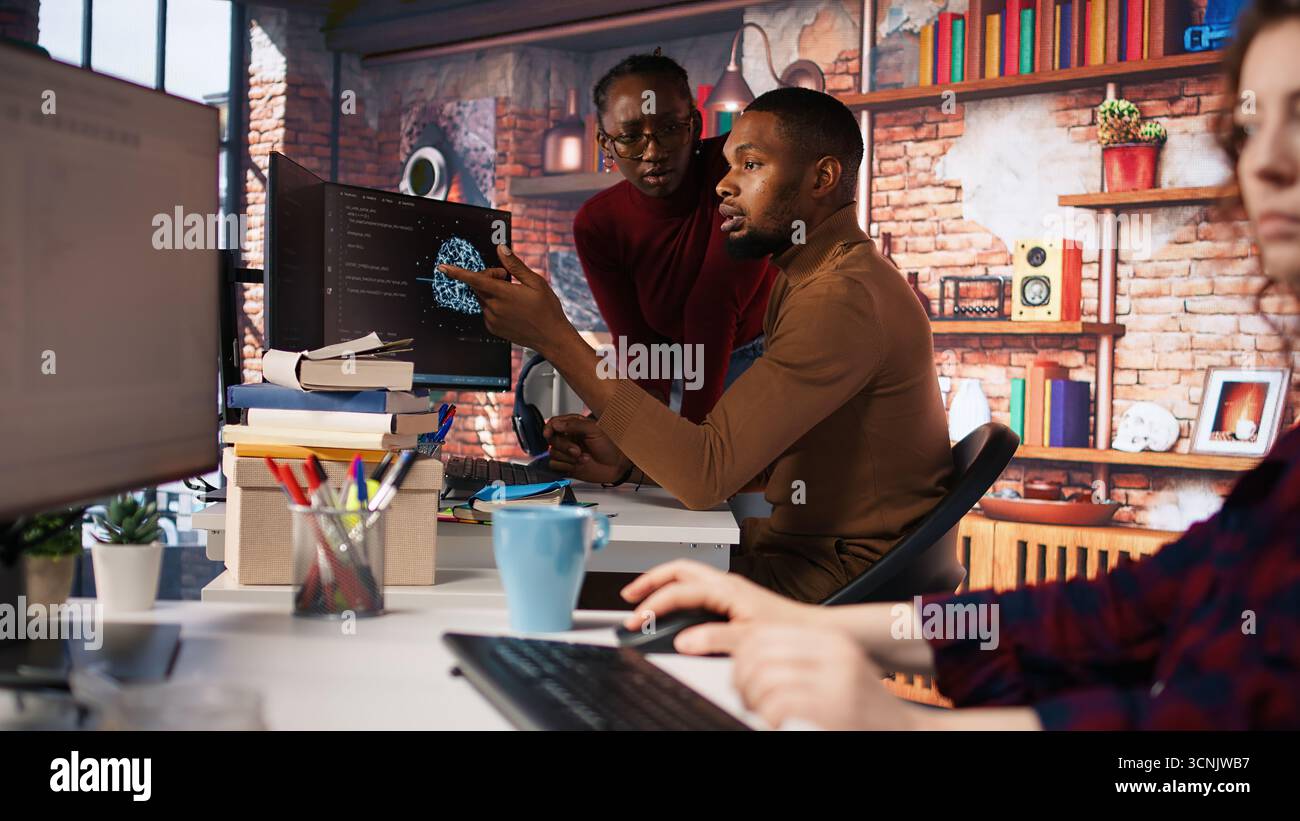 Team of startup workers conducting code review on PC to fix bugs, identifying technical issues with artificial intelligence company software. IT staff members optimizing code using device, camera A Stock Photo