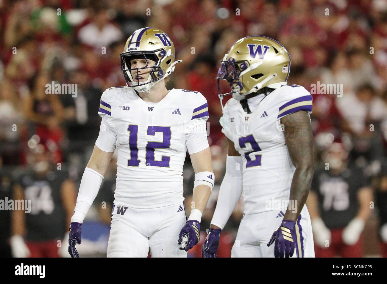Washington safety Alex McLaughlin (12) and cornerback Rahshawn Clark (2 ...