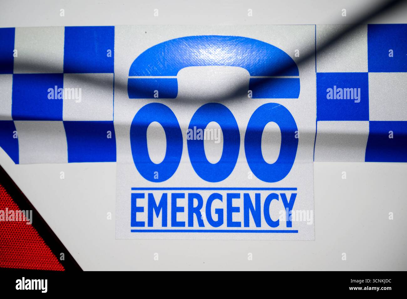 Signage for the Australian emergency call number Triple 000 is seen on ...