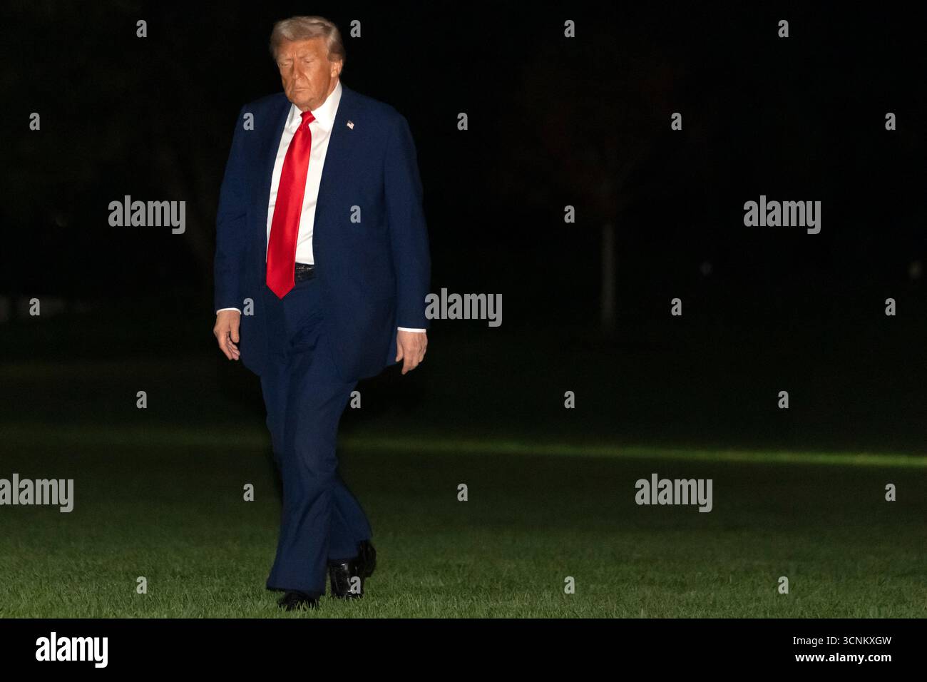 President Donald Trump walks across the South Lawn of the White House ...