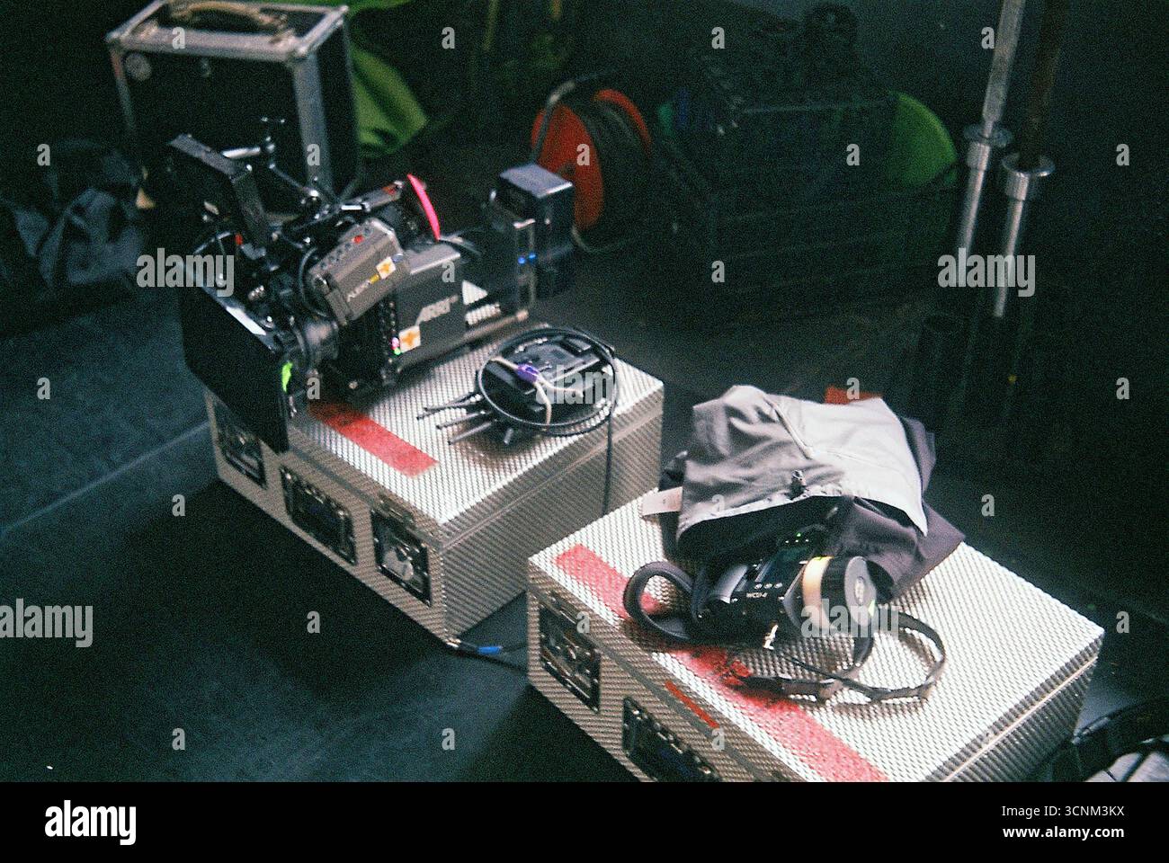 Arri Alexa Mini camera with wireless focus system resting on a case surrounded by lenses. Professional film equipment setup. Stock Photo