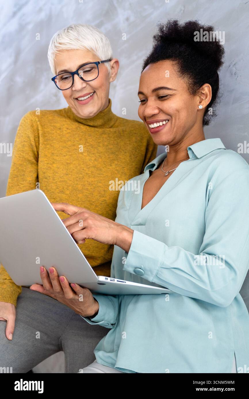 Mixed team of software engineers brainstorming ideas. Diverse app developers collaborating as group Stock Photo