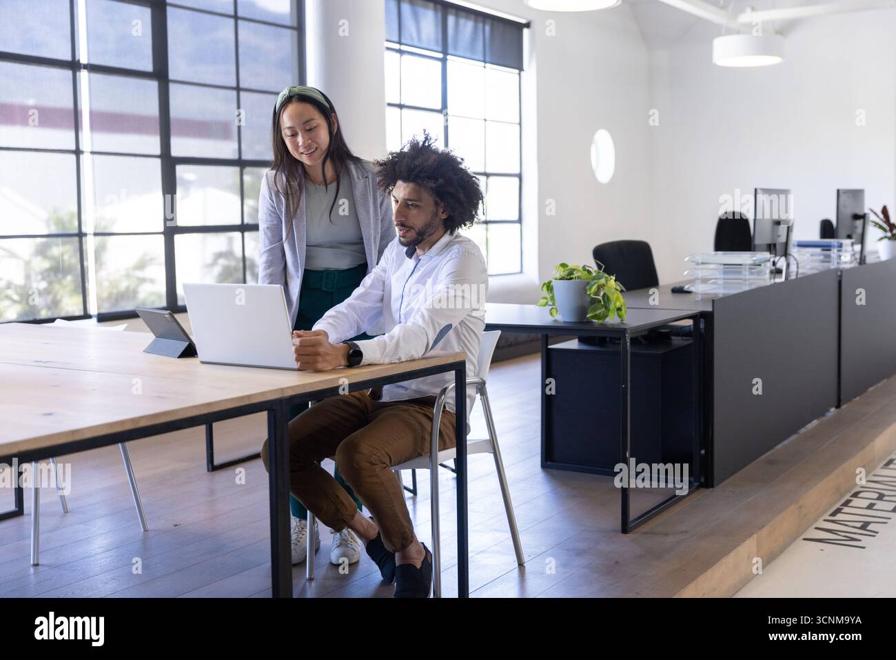 Diverse male coworkers leaning desk hi-res stock photography and images ...