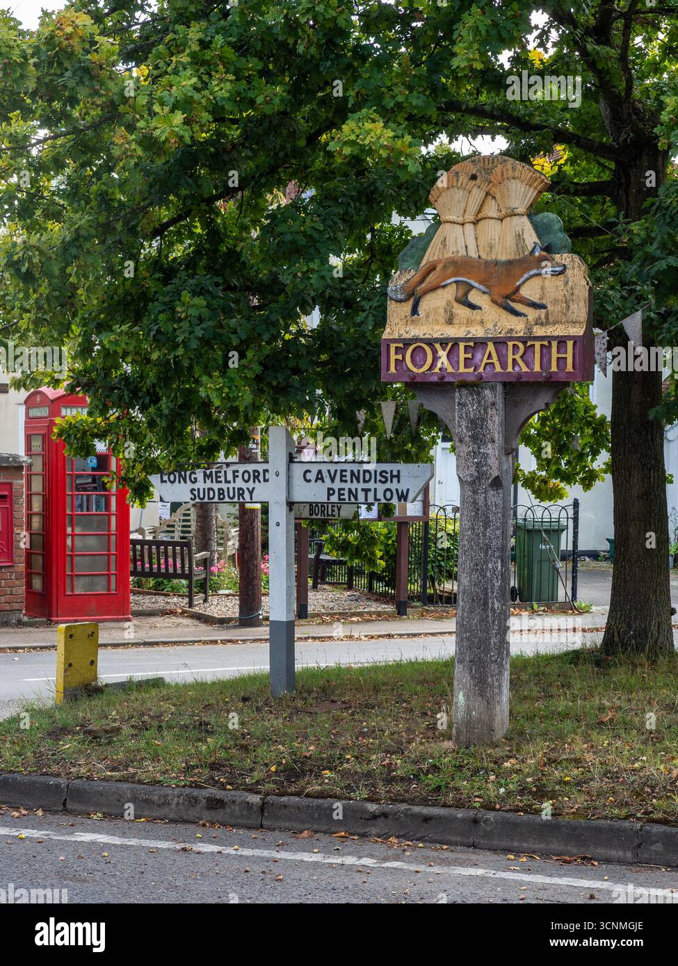 Traditional painted village sign for Foxearth, Essex, UK, depicting a fox and wheatsheaves symbolising the rural heritage of the village. Stock Photo