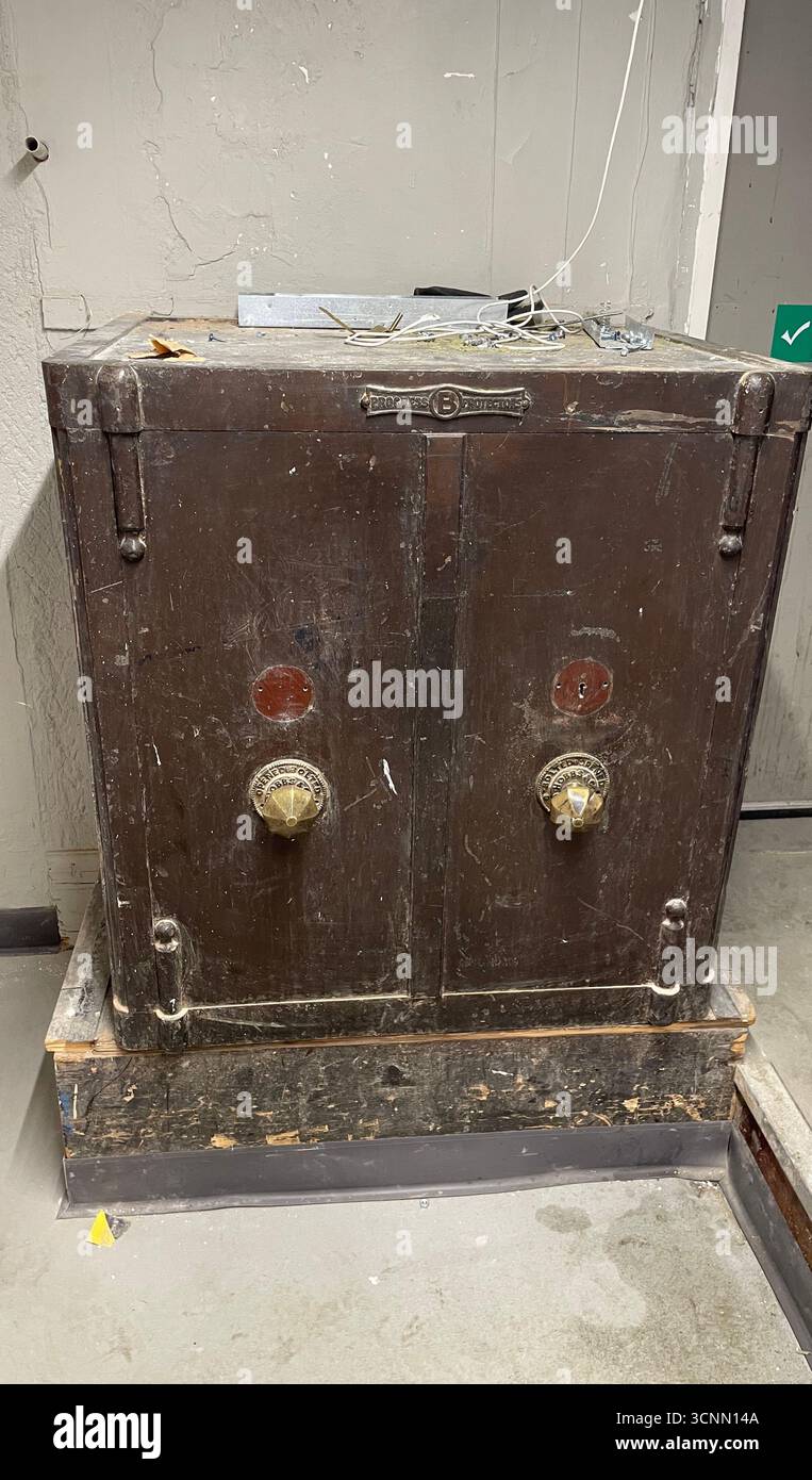 very old locked safe left in situ in store warehouse - Smartphone Captured Stock Image