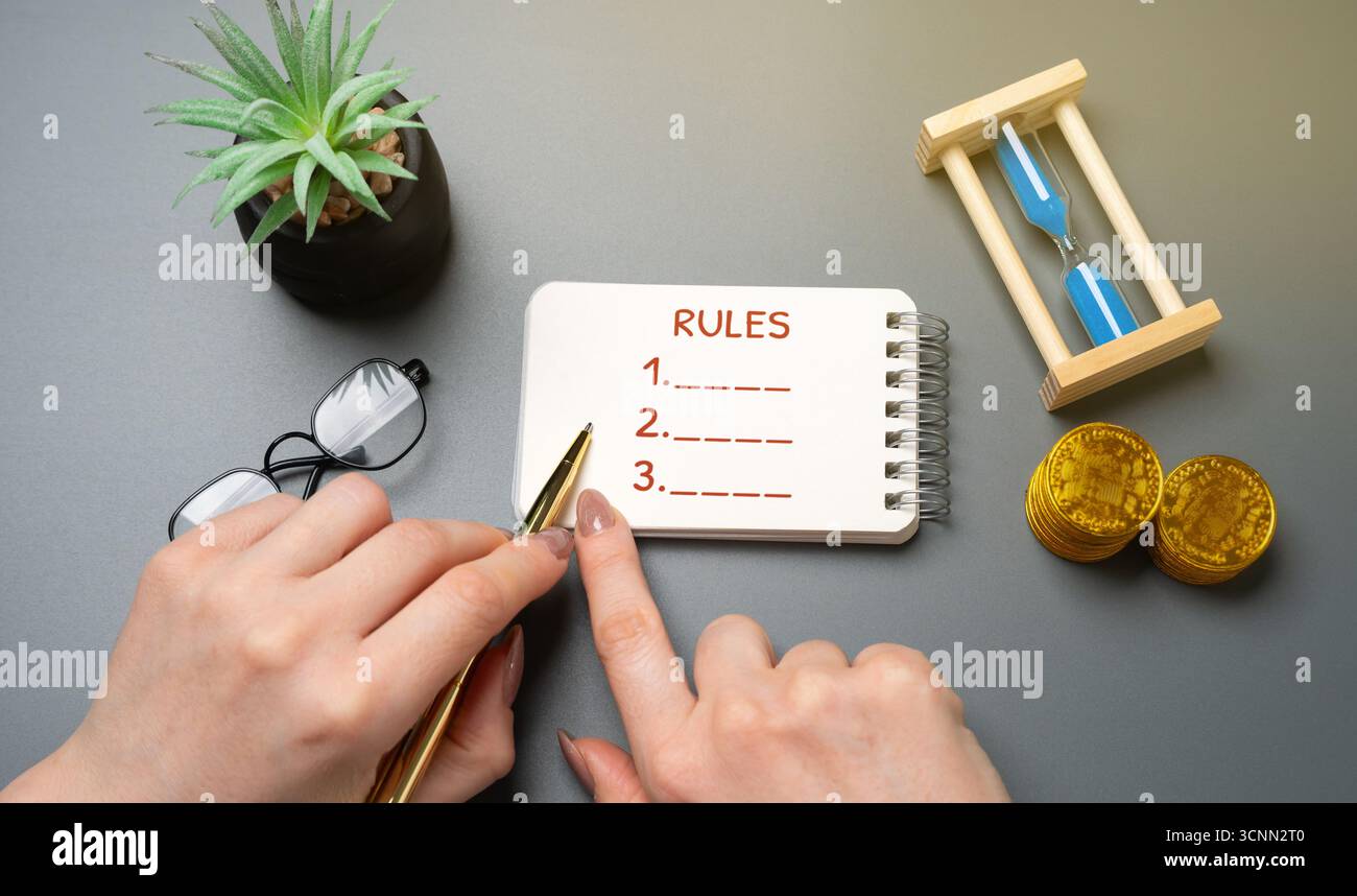 Notepad with the word Rules and numbered list. Concept of structure, discipline, workplace policies. Personal goals, guidelines, business organization Stock Photo