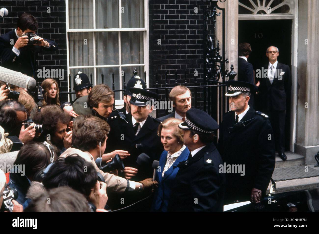 Mrs Margaret Thatcher Prime Minister May 4th 1979 UK. Following Conservative party win on May 3. Outside 10 Downing Street London. Meeting the waiting press having won the General Election. Denis Thatcher standing in the doorway of Number 10 waiting for her to finishing the press 1970s UK HOMER SYKES Stock Photo