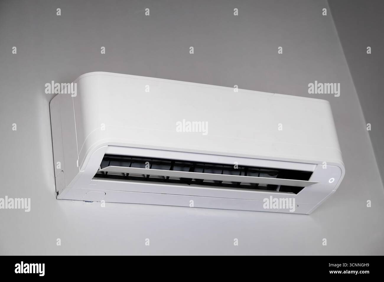 Modern split system air conditioner cooling apartment during summer heat, providing comfort and relief from high temperatures Stock Photo