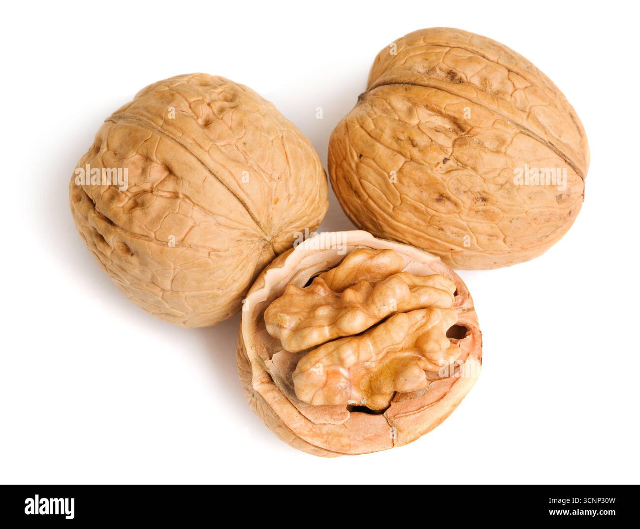 Three walnuts on white background Stock Photo - Alamy