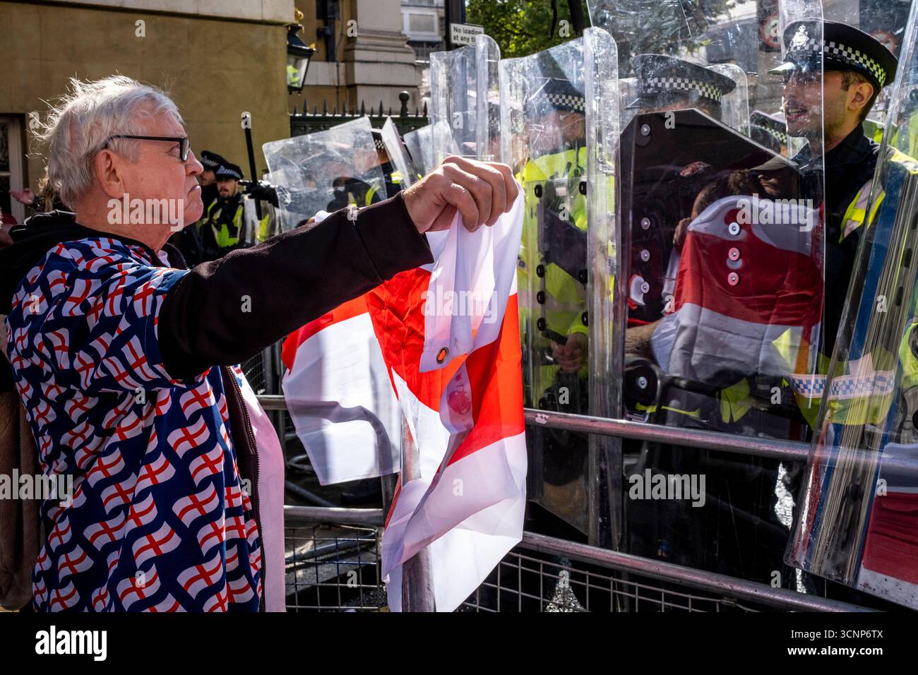 A Man Waves A Cross of St George Flag At Metropolitan Police Officers ...