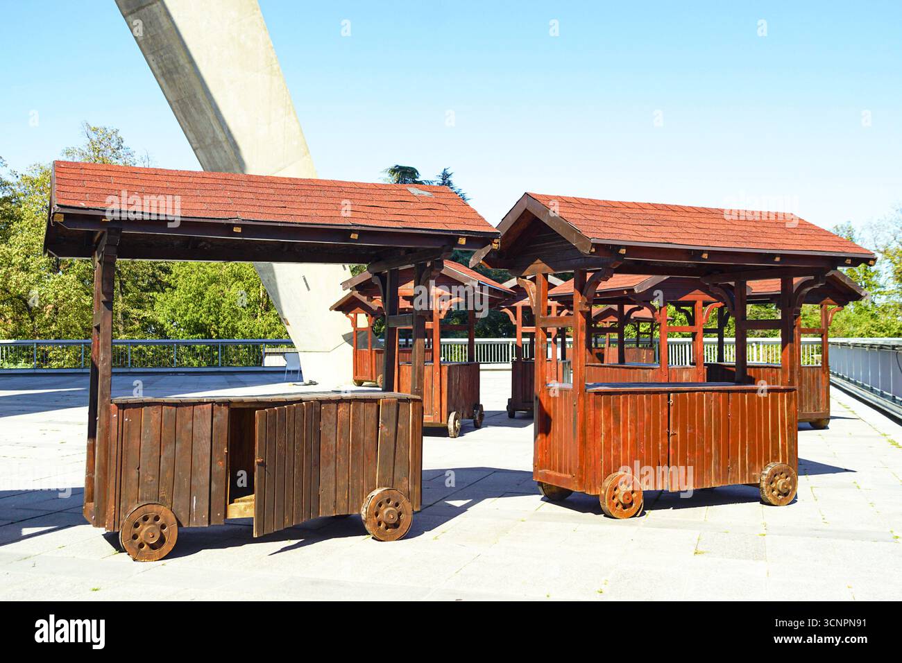 Empty wooden kiosks on the square: traditional carts with pitched roofs. Concept of seasonal market, handmade goods, eco living, slow food festivals Stock Photo