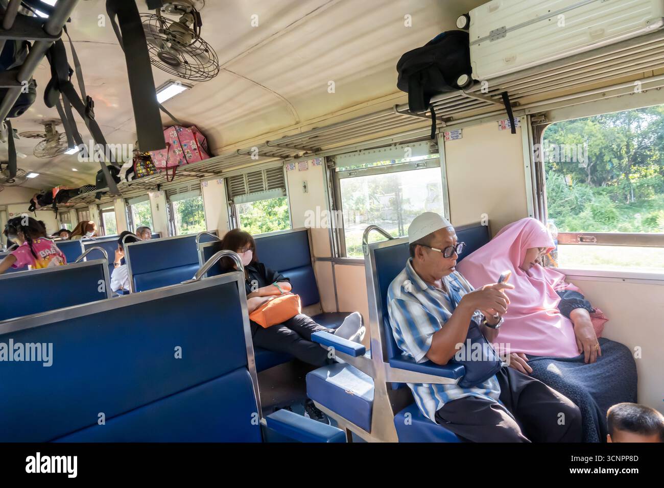 Thai Muslim family traveling on a domestic train, Thailand Stock Photo