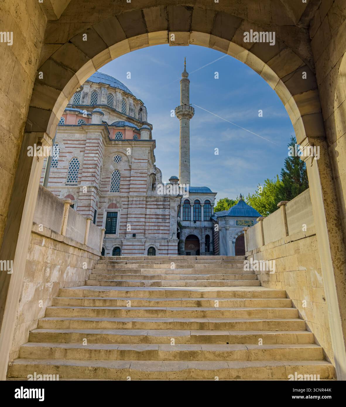Historic mosque view framed by stone arch and steps Stock Photo - Alamy