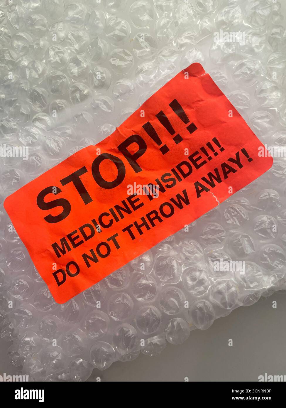 Warning sticker on bubble wrapped medicine do not throw away, 2025, United States - Smartphone Captured Stock Image