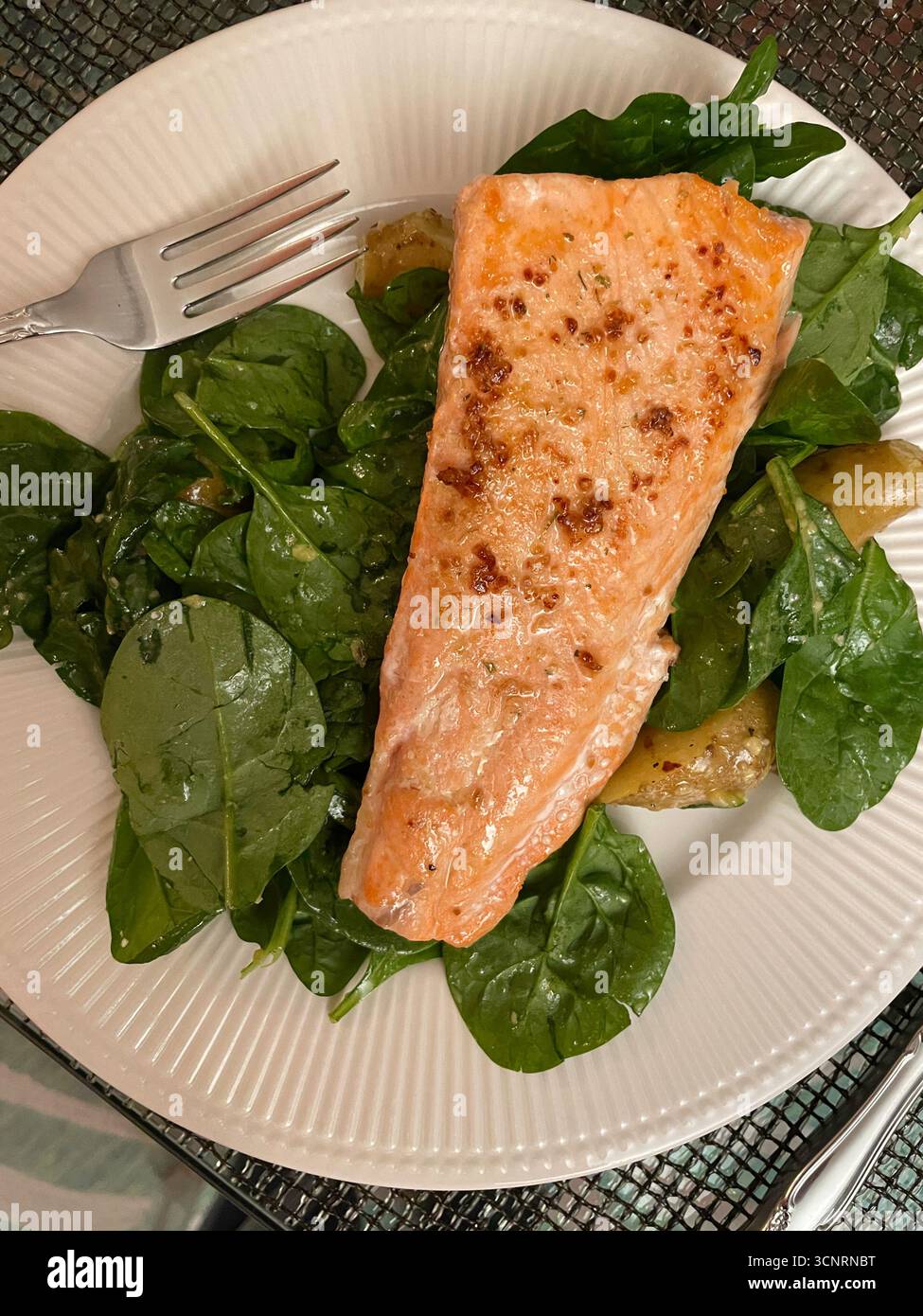 Close up of a gourmet seared salmon dish with dill ,arugula and new potatoes - Smartphone Captured Stock Image