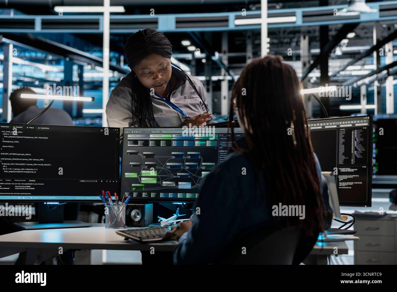 Data center manager supervising engineer setting up machine learning systems handling information. Supervisor oversees worker training node trees neural networks to improve server hub operations Stock Photo