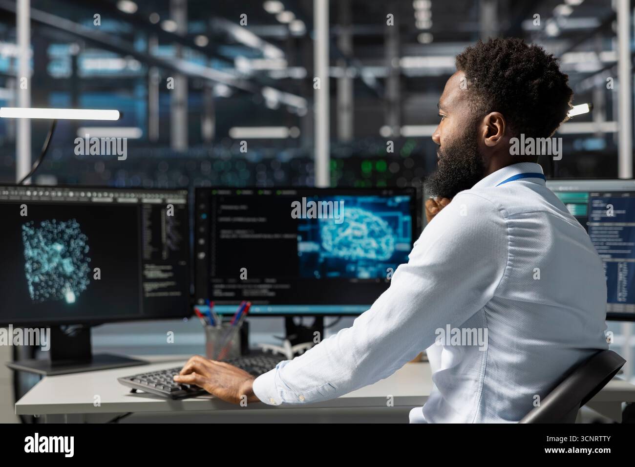 Server room worker using AI powered data visualization to perform demanding computing tasks. Admin in data center uses artificial intelligence predictive analytics for machine learning workloads Stock Photo