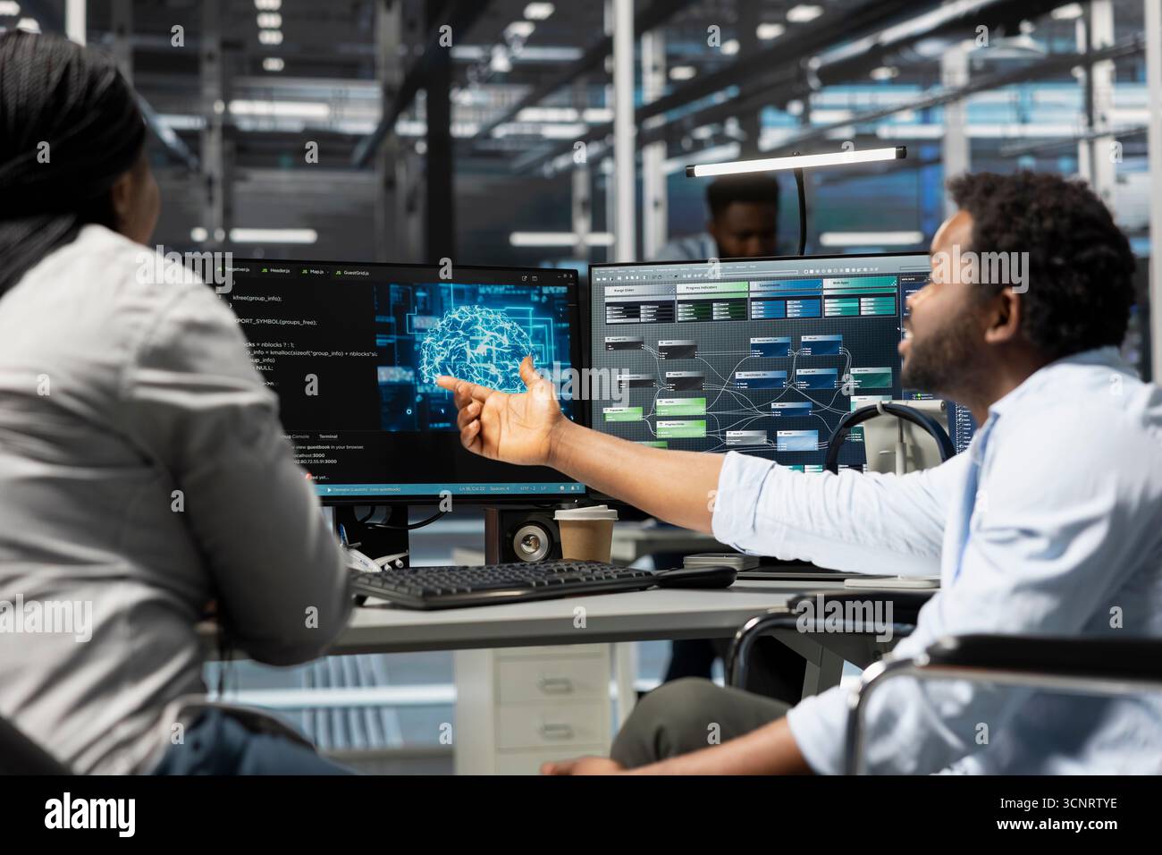 Data center manager and engineer with paraplegia using artificial intelligence computerized model. Server room team leader and worker in wheelchair using machine learning AI algorithms Stock Photo