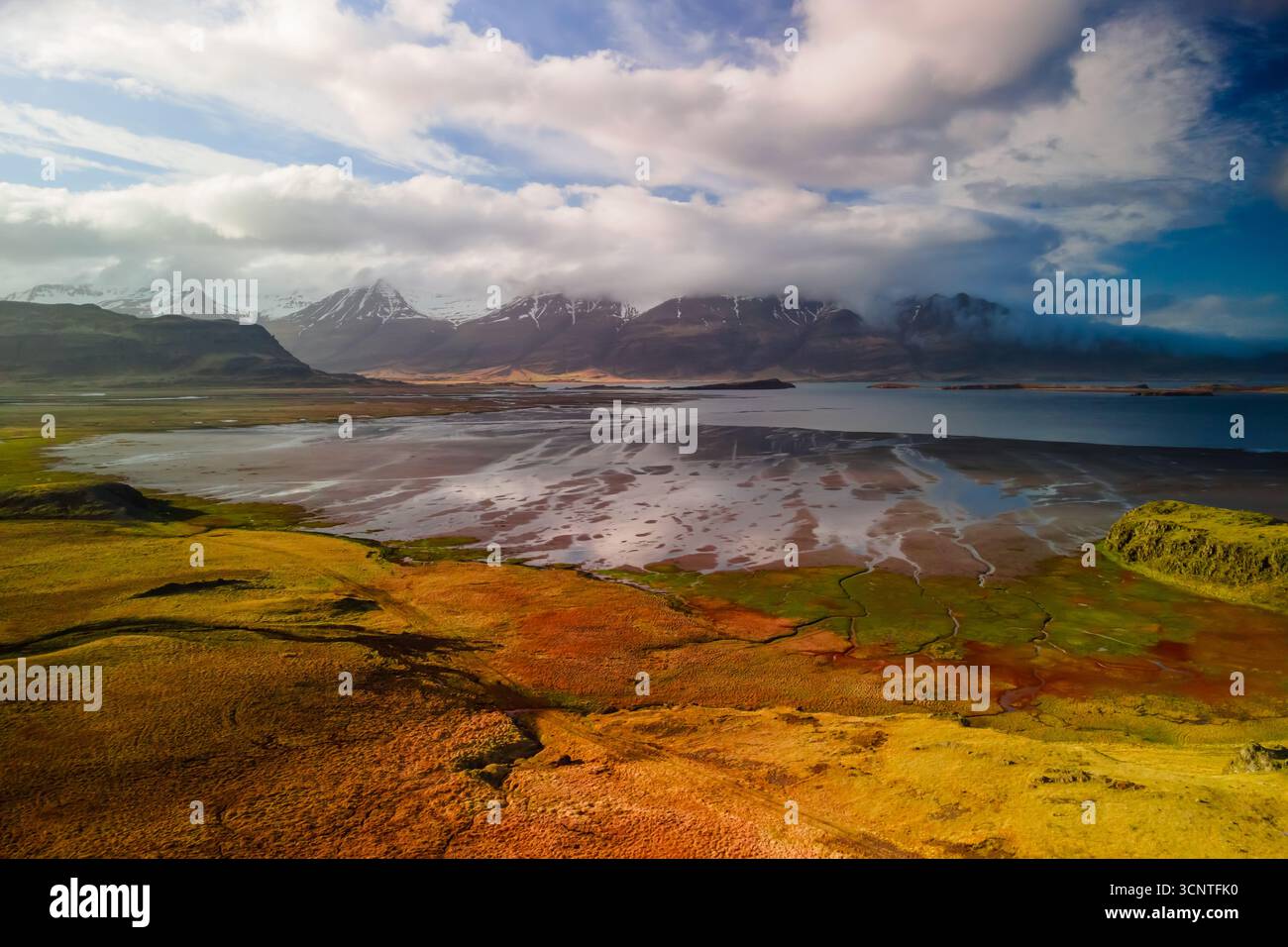Aerial view of scenic river and mountain landscape in Iceland countryside during spring time. Stock Photo