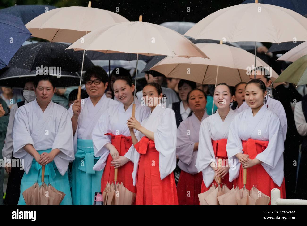 Officials in the Shinto priesthood watch a Japanese traditional dance ...
