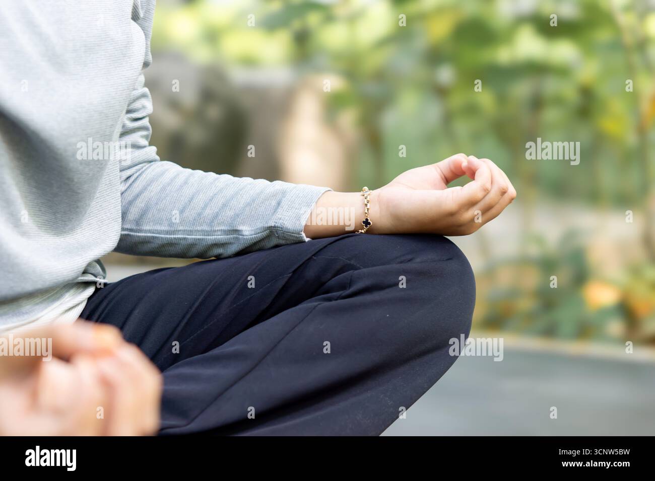 Closeup woman hand yoga lotus position at the park. Meditation and ...