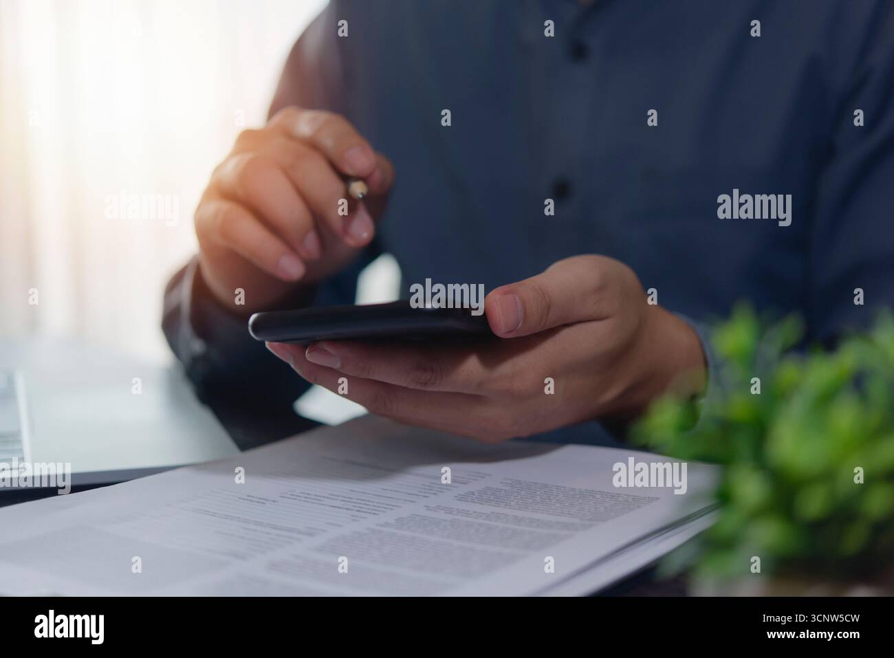 Business communication on smartphone: User checking data or messages, emphasizing mobile banking, secure transactions, and portable office capabilitie Stock Photo