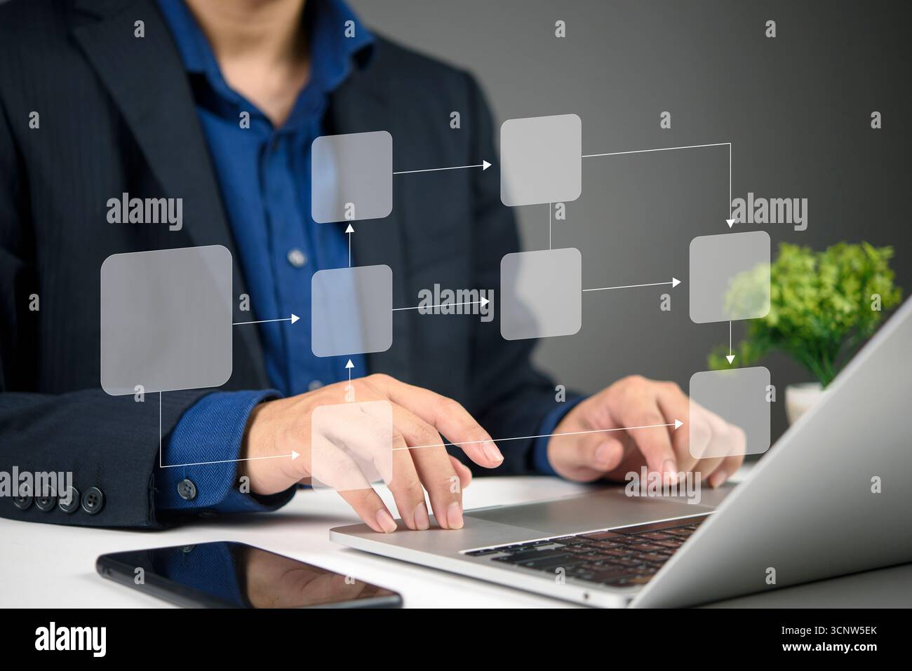 Business professional using a laptop to create a virtual flowchart, demonstrating digital technology for process organization and optimization. Stock Photo