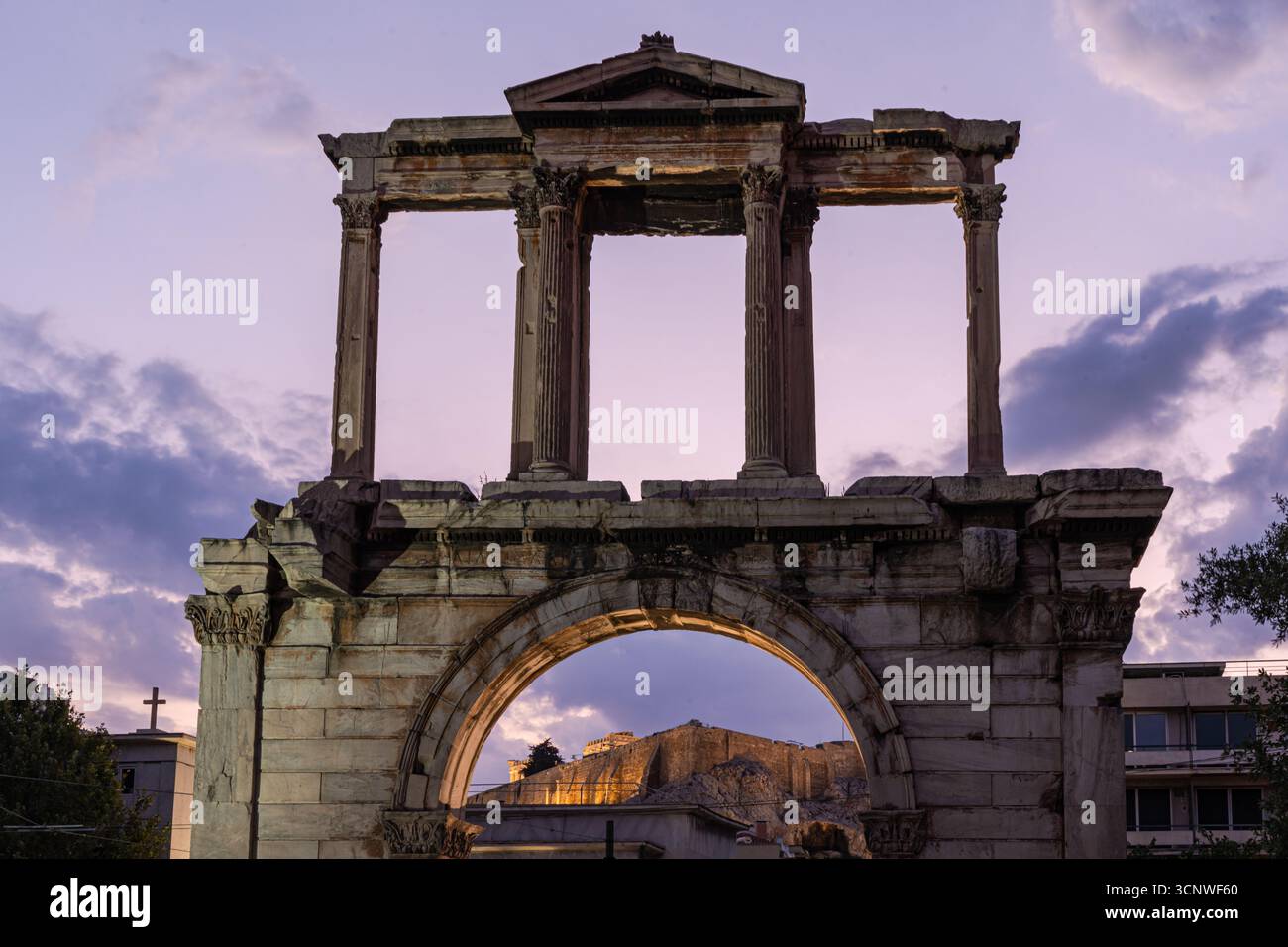 The iconic Hadrian's Arch in Athens stands majestically at sunset. This ...