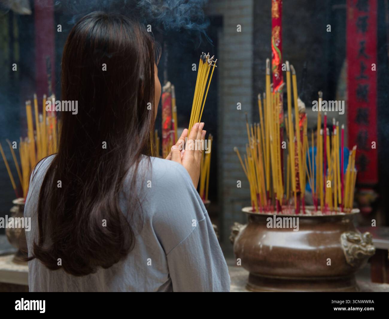 Worshiper holding incense sticks hi-res stock photography and images ...