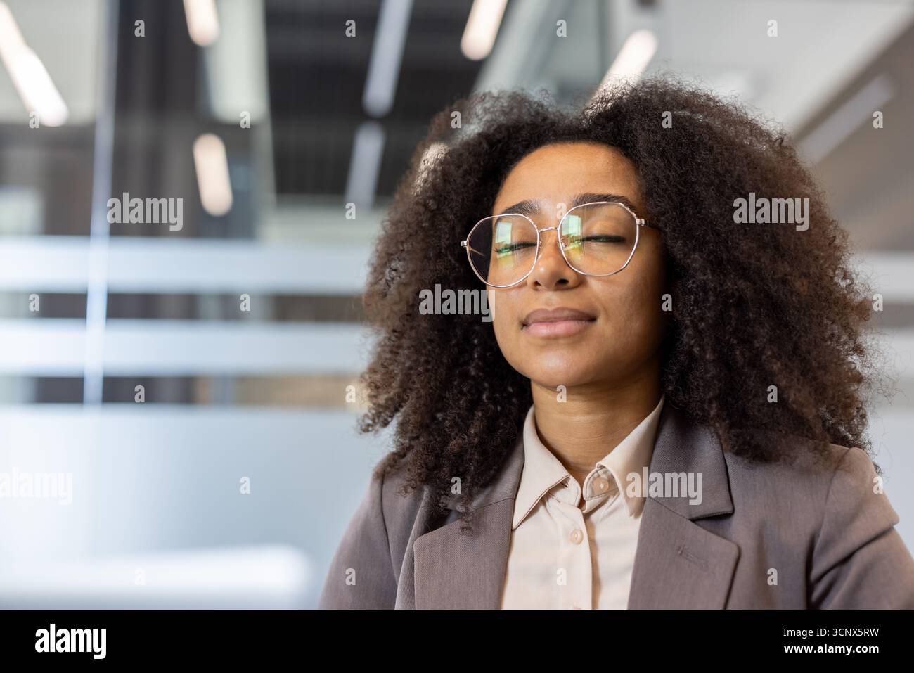 Close-up portrait of a young African-American woman in a suit and ...
