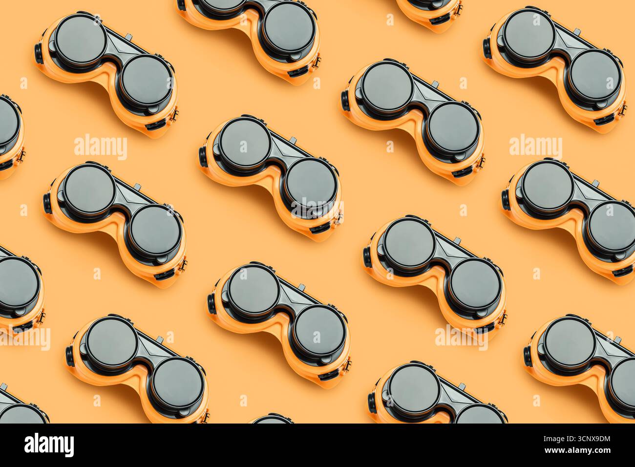 Multiple pairs of durable, yellow and black protective goggles arranged neatly on a bright background. Ideal for ensuring safety in construction and i Stock Photo