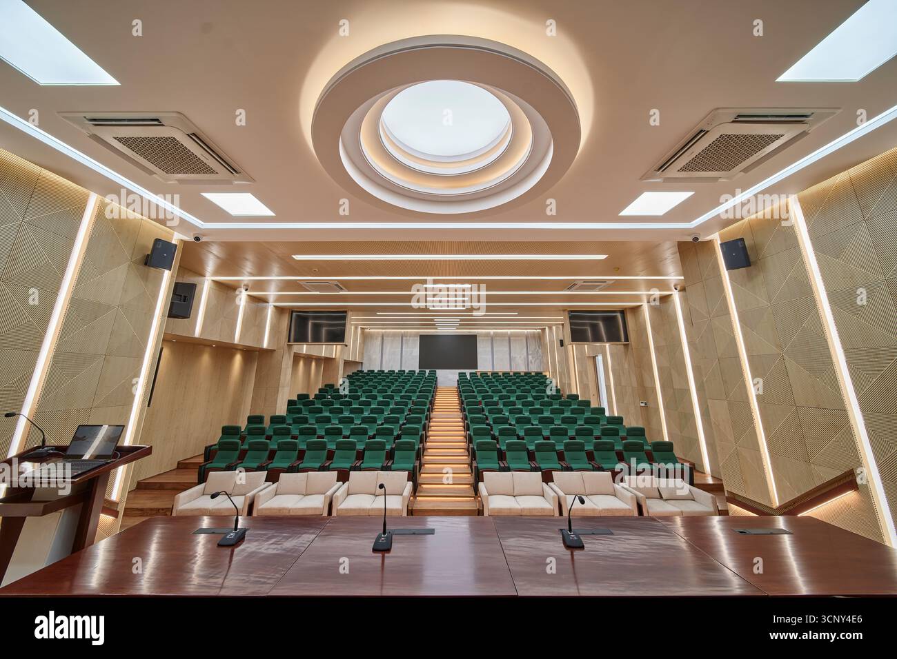Modern Auditorium with Tiered Seating and a Circular Skylight Stock Photo