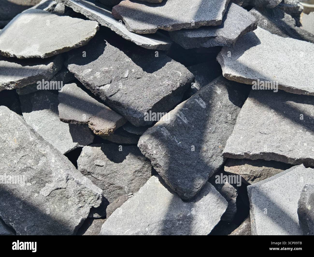 A stacked pile of natural stone slabs for wall cladding and construction materials Stock Photo