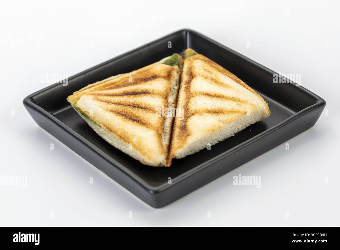 Close up of toasted triangle sandwich with pandan custard filling on ...