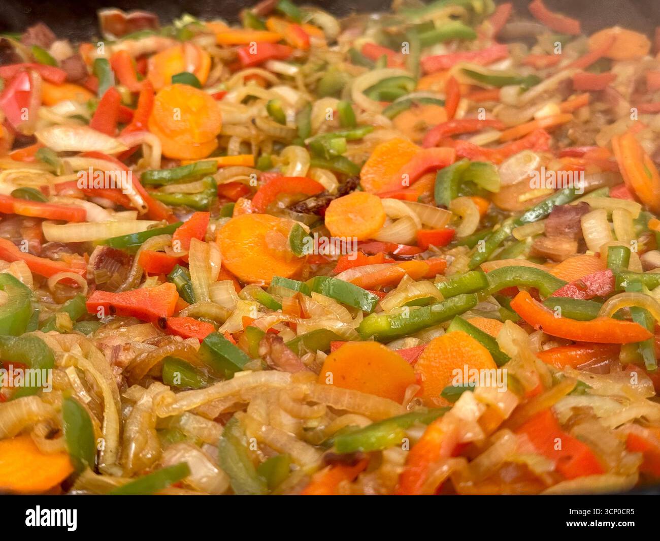 A vibrant stir-fry of chopped vegetables and diced meat cooking in a large pan, featuring carrots, peppers and onions. - Smartphone Captured Stock Image A vibrant stir-fry of chopped vegetables and diced meat cooking in a large pan, featuring carrots, peppers and onions. - Smartphone Captured Stock Image