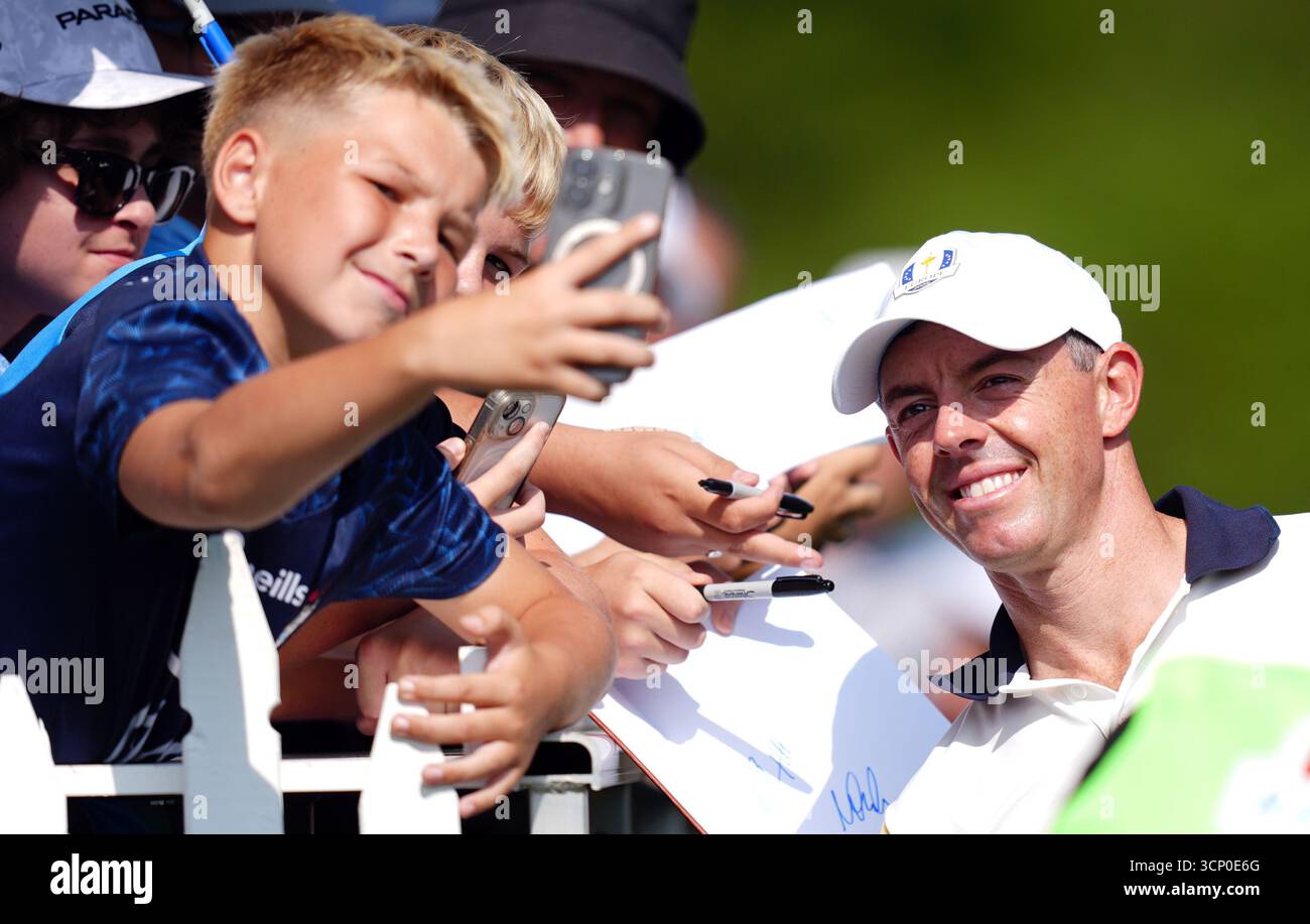 Young Congressmen Rory Rory McIlroy of Team Europe posses for a photo with a young spectator ...