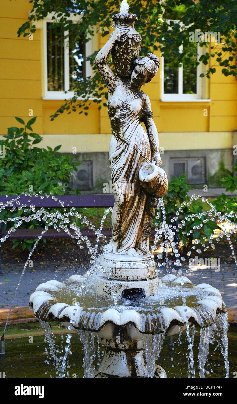 Water Bearer Stone Fountain in Fonyód City Center,Hungary Travel Tip Stock Photo