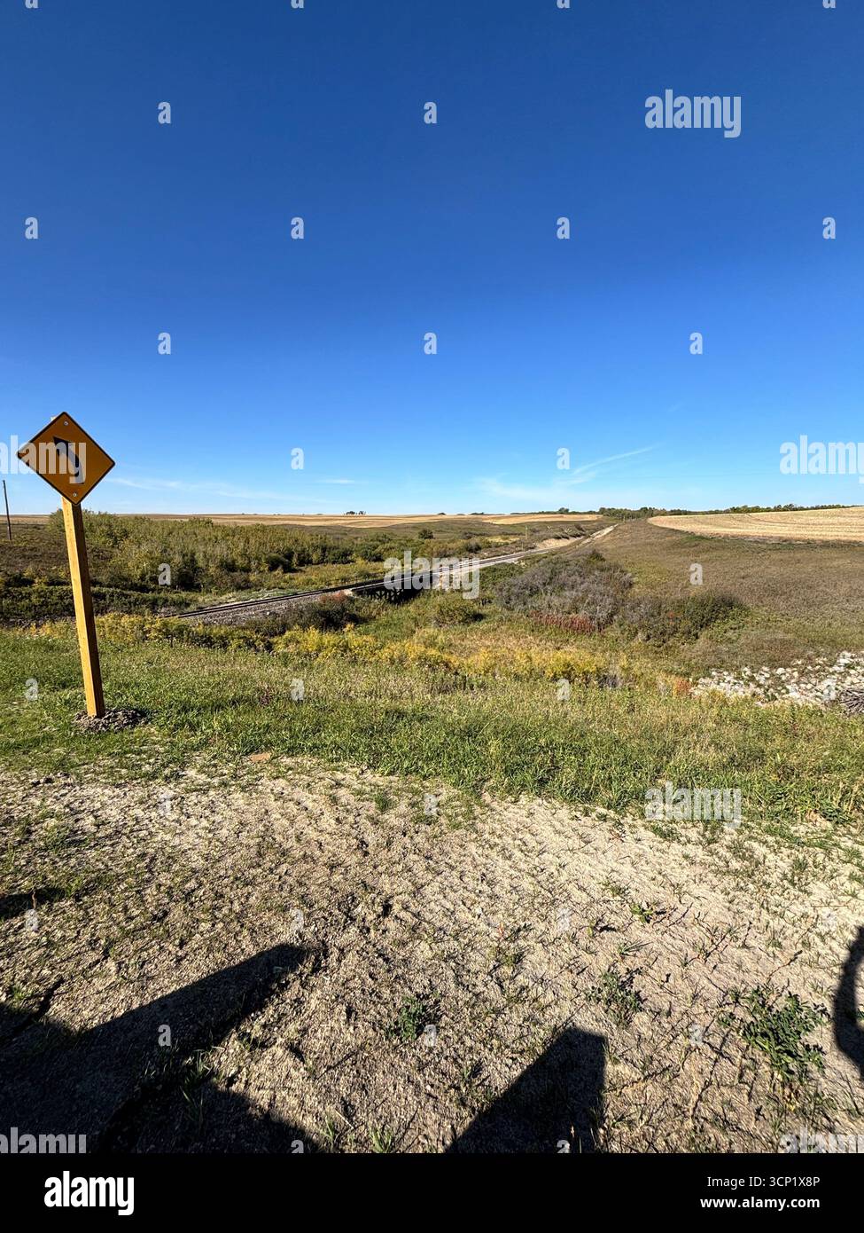 ''A lone rail bridge crosses a small creek on the vast prairie, leading the way to open country under a perfect blue sky.'' - Smartphone Captured Stock Image ''A lone rail bridge crosses a small creek on the vast prairie, leading the way to open country under a perfect blue sky.'' - Smartphone Captured Stock Image