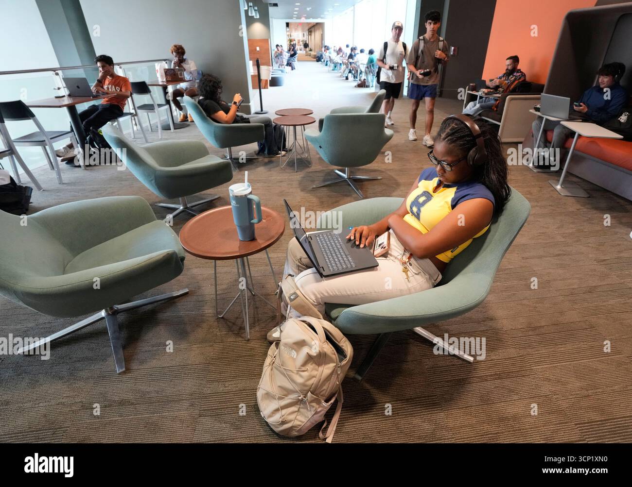 Students using laptop computers sit in lounge chairs and study over the lunch hour at the William C. Powers Student Activity Center at the University of Texas at Austin on September 11, 2025. UT-Austin has enrolled over 50,000 students for the fall, 2025 semester. Stock Photo