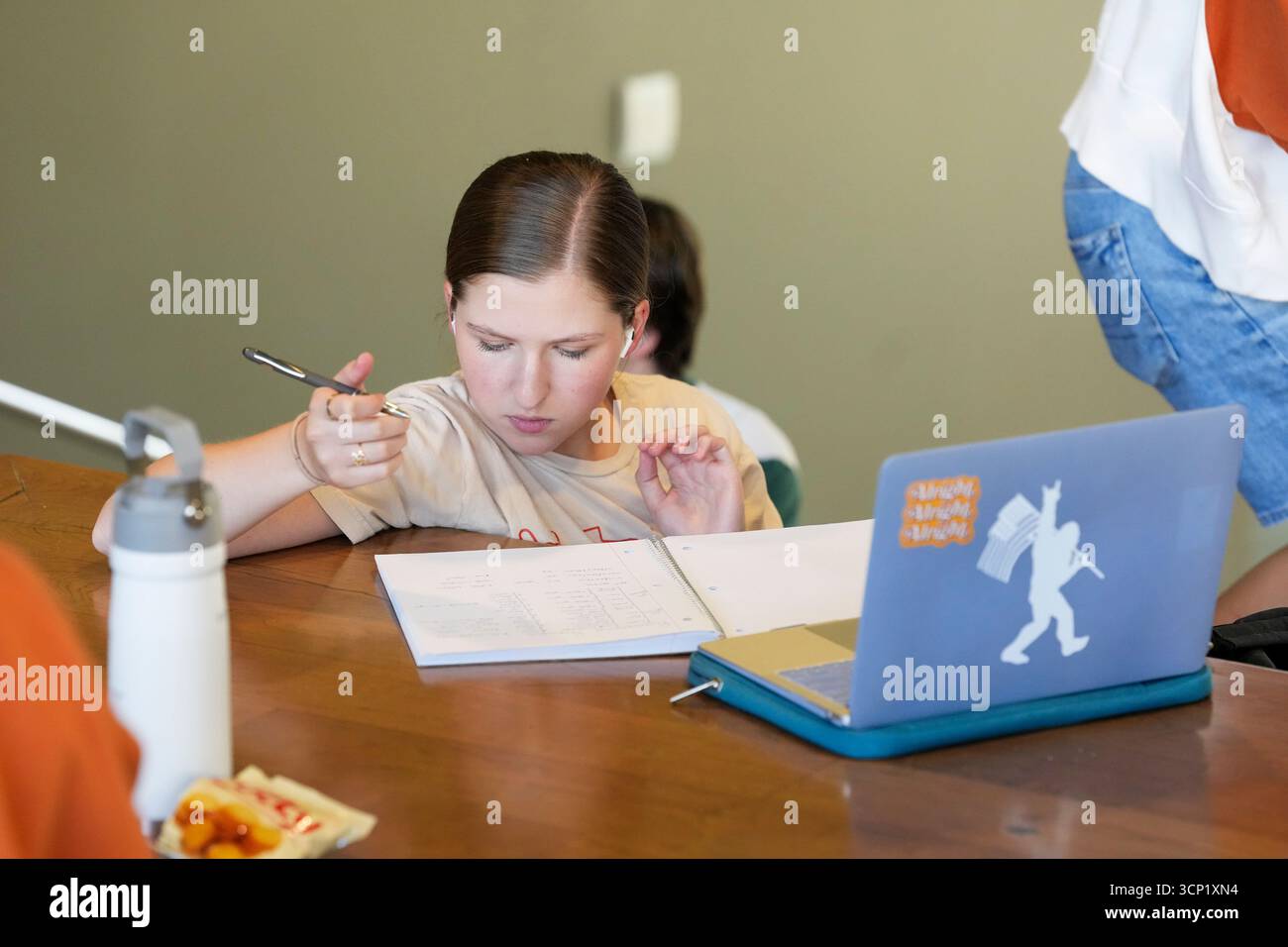 Student using her laptop computer and taking notes over the lunch hour at the William C. Powers Student Activity Center at the University of Texas at Austin on September 11, 2025. UT-Austin has enrolled over 50,000 students for the fall, 2025 semester. ©Bob Daemmrich Stock Photo